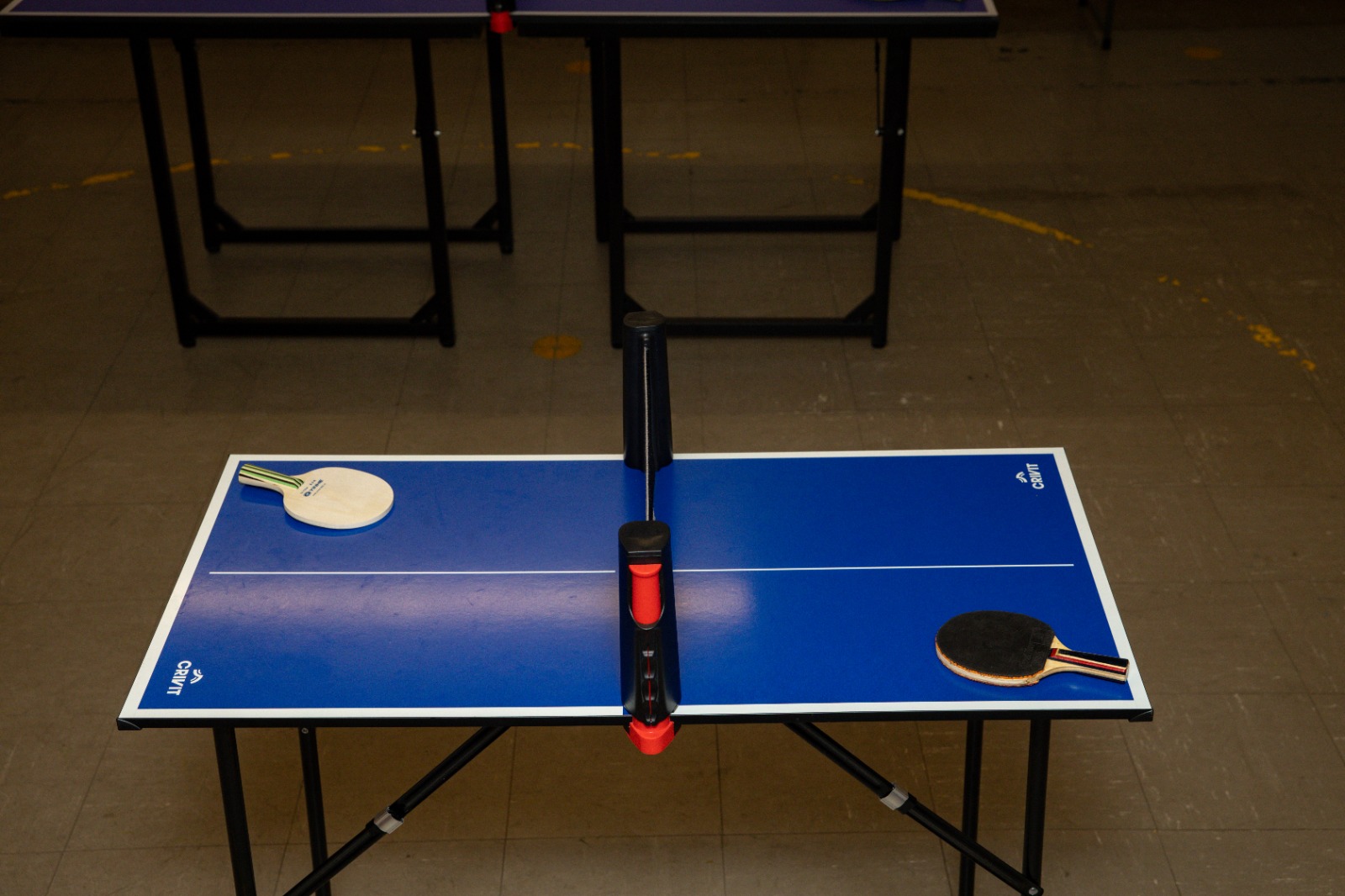 A miniature blue table tennis table with bats